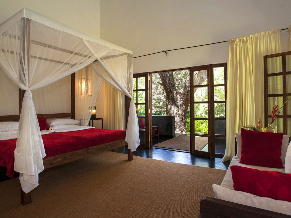 Canopy bed and garden doors at The Plantation Lodge